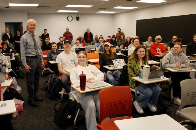 Peter Hahn stands amid his classroom of students.