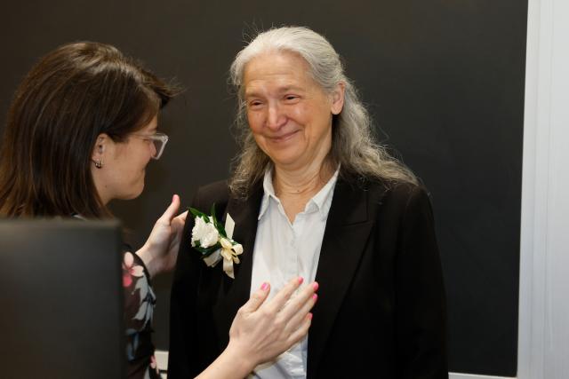 Camille Hebert receives a congratulatory corsage from a colleague.