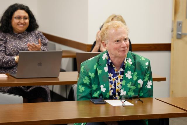 Mitch Lerner and colleagues sit in a classroom during his surprise visit from leadership.